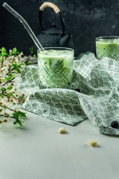 Iced Matcha Latte with a straw tugged into it