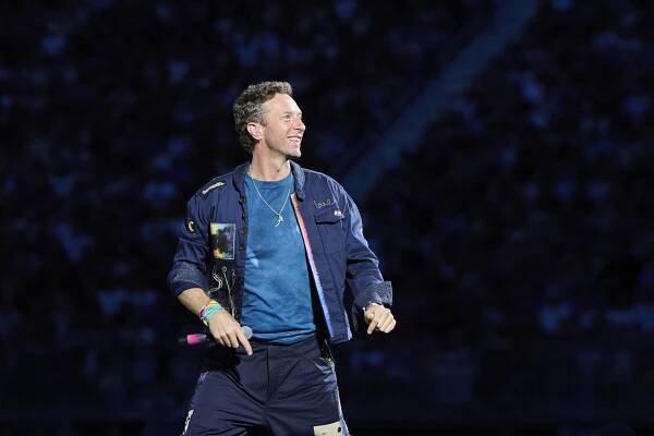 Chris Martin of Coldplay performing on stage.