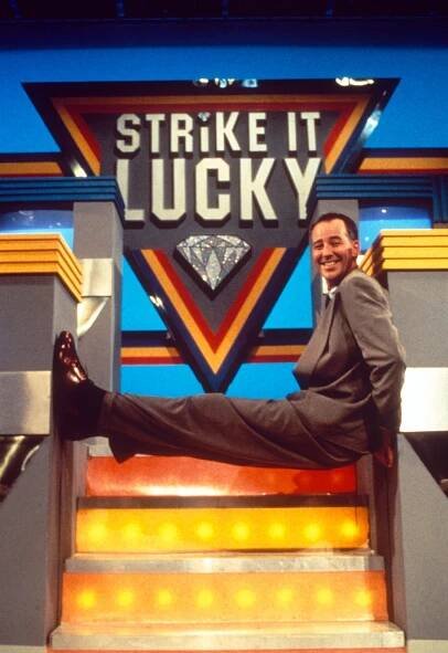Michael Barrymore in a hospital bed, explaining that a mini-stroke caused him to develop epilepsy with uncontrollable seizures.