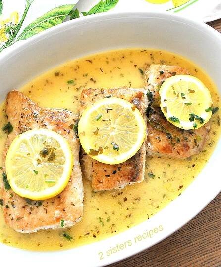 Mahi Mahi fish served in with a lemon sauce in a white platter.