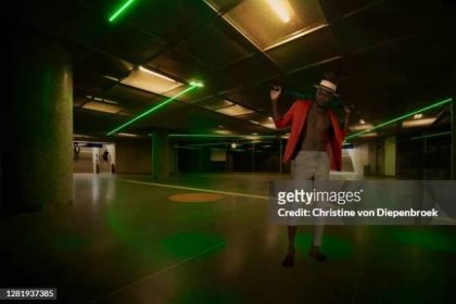 black male model in neon light at underground tube - young models tube stock pictures, royalty-free photos & images