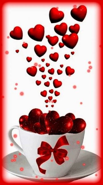 a white cup filled with red hearts on top of a saucer