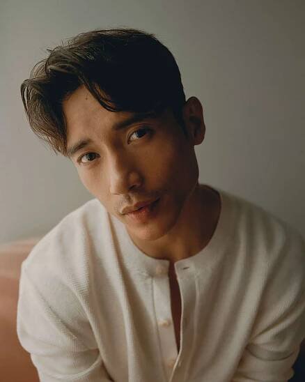 Manny Jacinto looking towards the camera