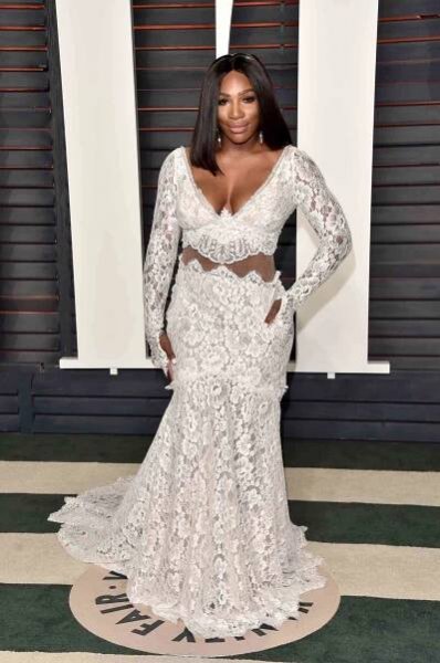 Serena Williams wears a long-sleeve white lace gown in 2016, one of Serena Williams' best red carpet looks.