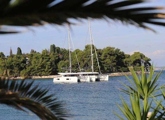 Two Catamarans anchor in a bay, Catamaran sailing in Greece