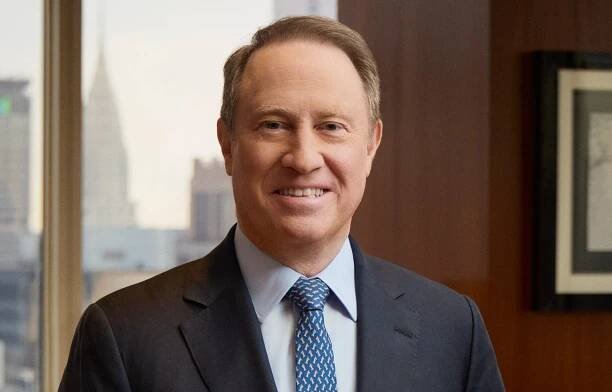A man smiles at the camera