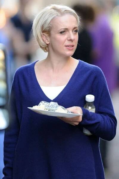 a woman holding a plate with food on it