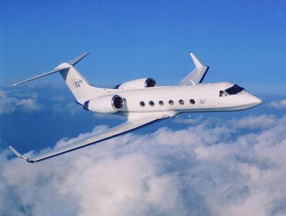 Gulfstream G-IVSP flying above the clouds