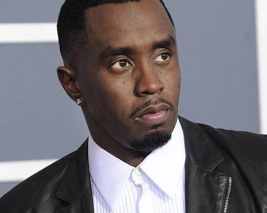 Sean Combs, in a white shirt and black jacket.