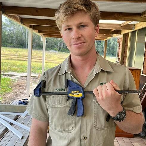 Robert Irwin holding a clamp.