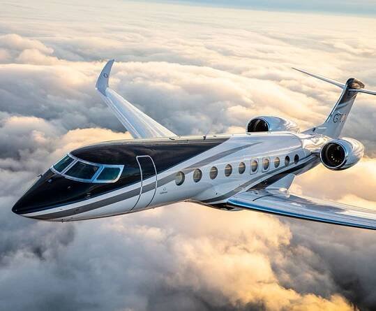 G700 flying at sunset over clouds