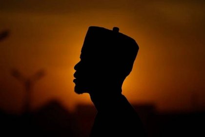  An atheist stands against the sunset sky in Kano Nigeria, Friday, July 14, 2023. (AP Photo/Sunday Alamba) 