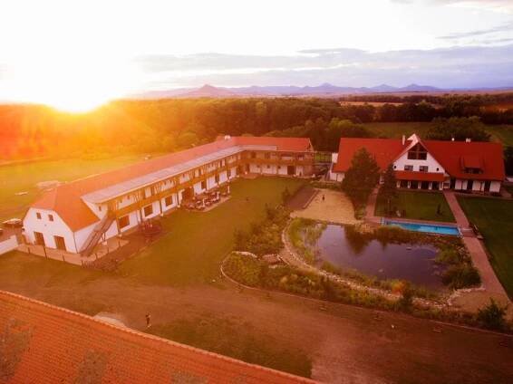 an aerial view of a large building with a pond at Dvůr Perlová voda in Budyně nad Ohří