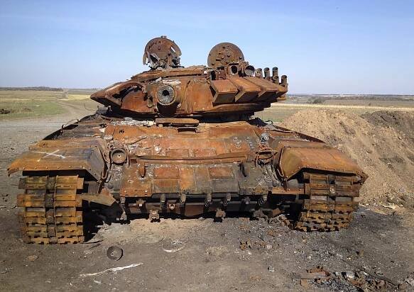 A destroyed T-72 tank  is seen on a battlefield near separatist-controlled Starobesheve