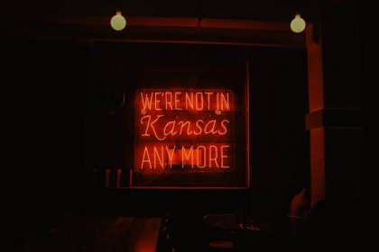 we're not in Kansas anymore red neon signage turned on