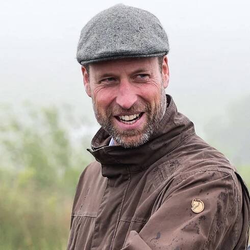 Britain's Prince William, Prince of Wales (C) speaks with representatives from the local Fire Service during a visit of an area of restored peatland at Dartmoor National Park