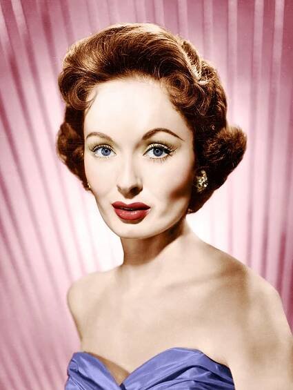 an old photo of a woman in a blue dress with red lipstick on her lips