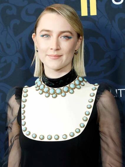 Saoirse Ronan with bright blue eyeshadow in the shape of wing tips