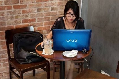 Woman working on a laptop computer.