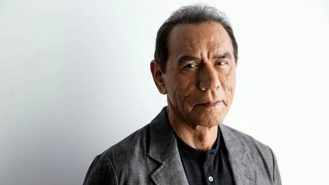 Portrait of actor Wes Studi wearing a gray sport coat and black shirt.