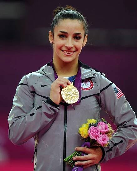 Gold medalist Alexandra Raisman of the United States poses on the podium during the medal ceremony for the Artistic Gymnastics Women's Floor Exercise final on Day 11 of the London 2012 Olympic Games at North Greenwich Arena on August 7, 2012