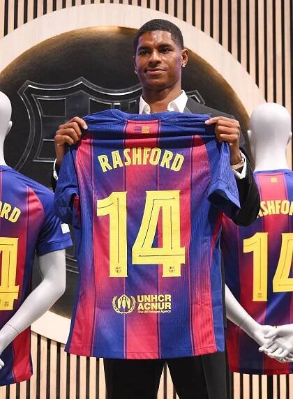 Photo shows Marcus Rashford holding up his new Barcelona Football Club shirt with his surname and the number 14 etched on