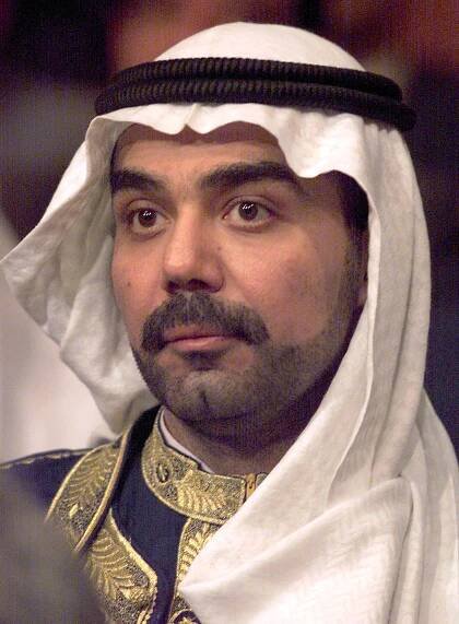 Saddam Hussein's eldest son Uday (R) attends a Par