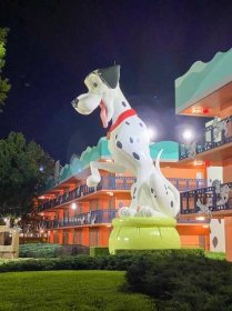 Large Pongo Dalmatian statue brightly lit up at night at Disney's All Star Movies