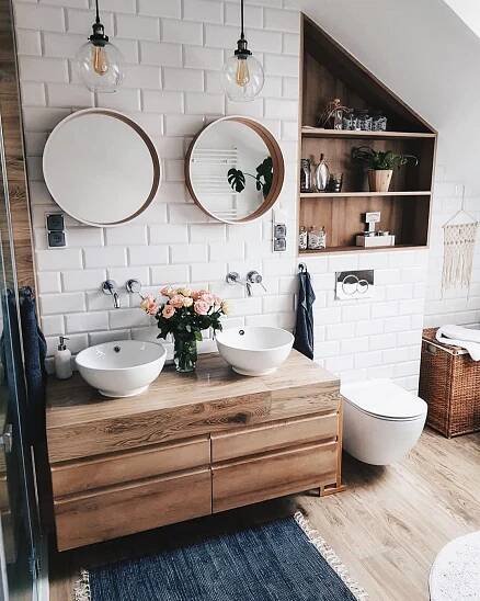 two white sinks sitting on top of a wooden counter in a bathroom next to a toilet