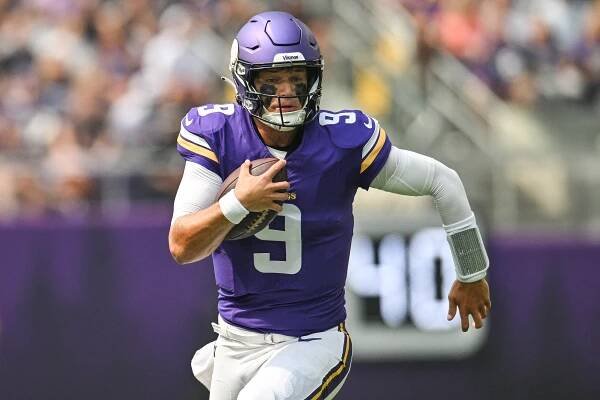Minnesota Vikings quarterback J.J. McCarthy (9) scrambles for a gain against the Houston Texans during the first quarter at U.S. Bank Stadium.