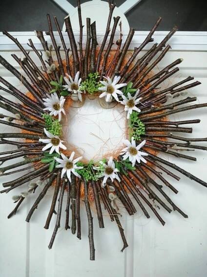 a wreath made out of sticks and flowers
