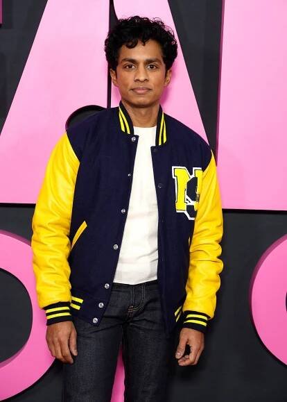 Rajiv Surendra in a letterman jacket on the red carpet for the "Mean Girls" NY premiere