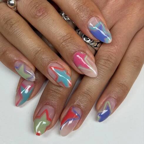 a star nail design with bright y2k colors