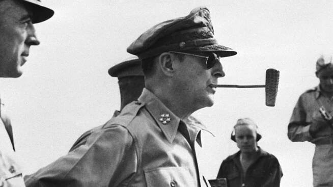 General Douglas MacArthur with a corn cob pipe in profile