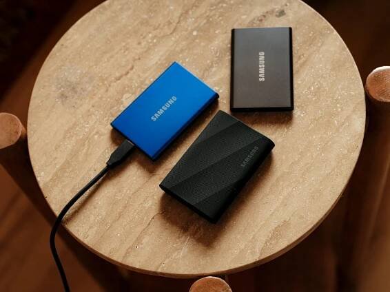 A table with a charger and a laptop on it