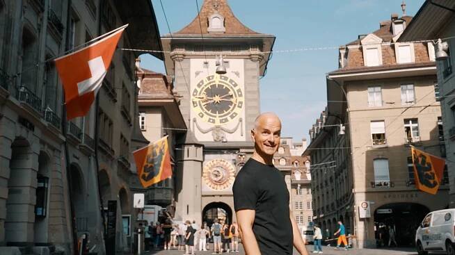 Christoph Maria Herbst standing in a city in Switzerland, german actor, smiling