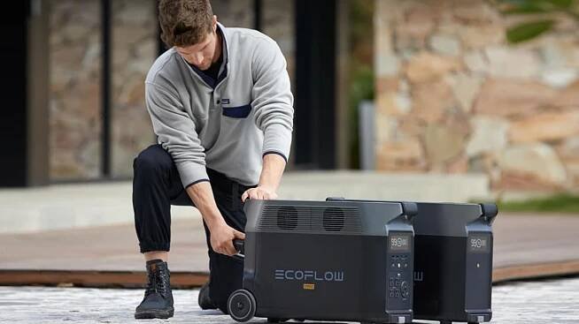 man connecting DELTA Pro power station to extra battery on deck