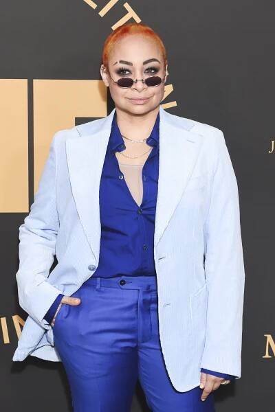 Raven Symoné on red carpet wearing a stylish suit and sunglasses
