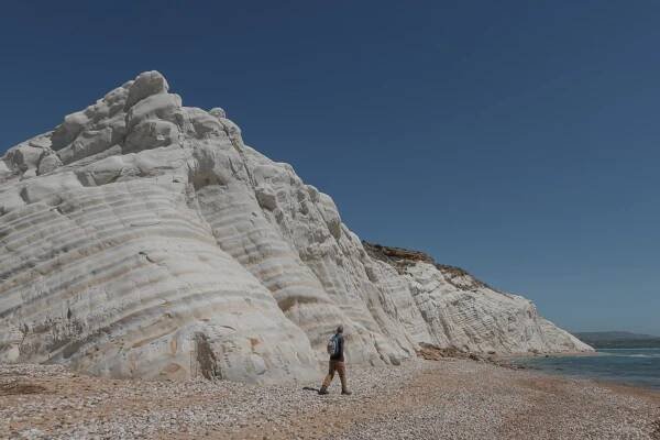 Dan walks on sand and pebbles