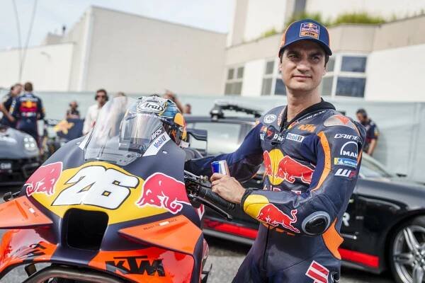Dani Pedrosa poses next to his KTM bike from Red Bull KTM Factory Racing
