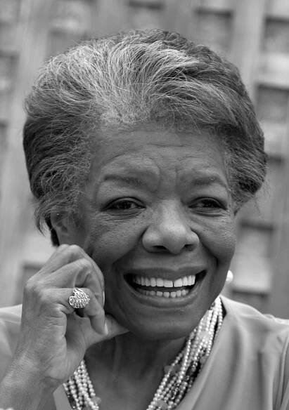 Maya Angelou with a glowing smile and a soft hand at her cheek.
