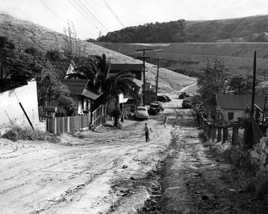 Two children walk up a dirt road in the Chavez Ravine area in 1950. Photo Leonard Nadel, courtesy of the Southern California Library for Social Studies & Research.