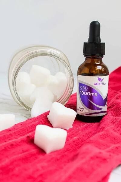 side view of CBD Oil Pulling Chews and a bottle of CBD oil