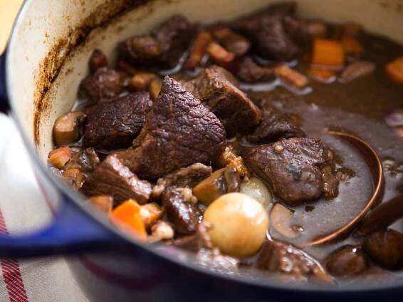 Close up view of boeuf Bourguignon in a pot ready to serve. 
