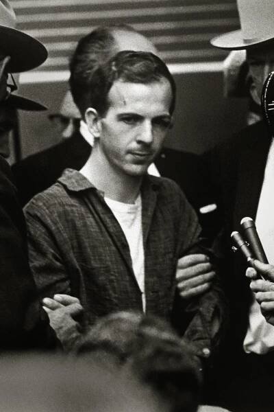 Guards and secret service agents escorting Lee Harvey Oswald through the Dallas police headquarters two days after his arrest in conjunction with the assassination of President Kennedy. Jack Ruby assassinated Oswald moments after this photo was taken.