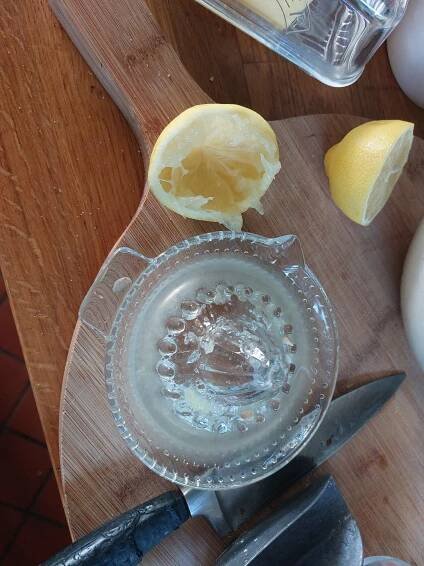 Freshly juiced lemon for lemon and raisin pancakes which just work, using a vintage glass citrus squeezer.