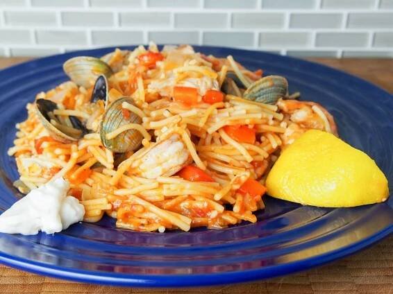 Fideua is a Catalan fish and seafood paella made with short pasta and a tomato-pepper and stock sauce base. Deliciously comforting.