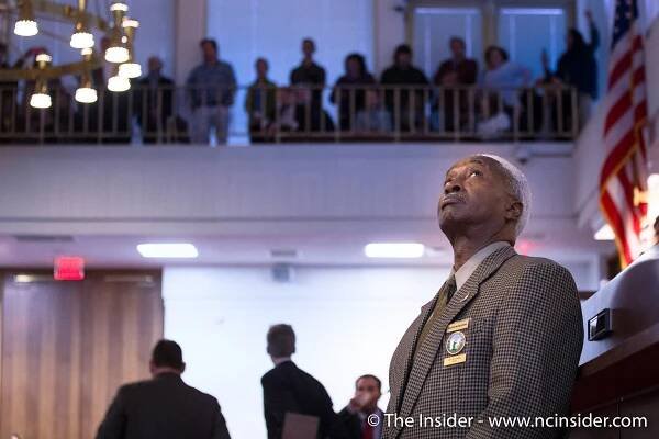 RALEIGH, N.C. - House Asst. Sgt.-at-Arms Malachi McCullough stands before the North Carolina House of Representatives as protests begin to break out in the gallery on Dec. 15, 2016. The House was debating Republican-sponsored legislation that would strip certain powers from incoming Governor-elect Roy Cooper. The galleries were eventually cleared by police. (Clifton Dowell | NCInsider.com)