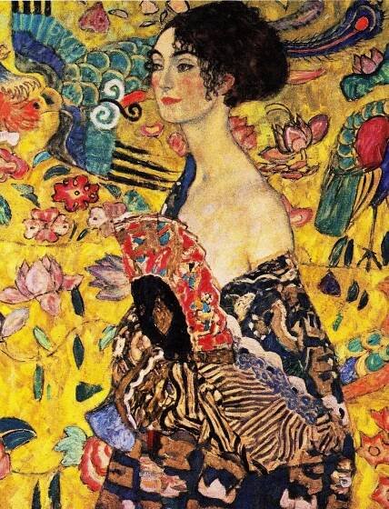The image is a painting of a woman in a black and gold dress with a fan in her hand. She is standing in front of a yellow background with a pattern of flowers and leaves. The woman has a relaxed expression on her face and is holding the fan in her right hand. The painting is in the style of the Art Nouveau movement.