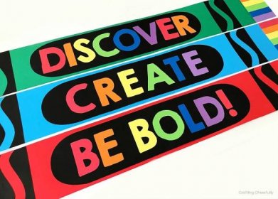 Three large colorful paper crayons that read Discover, Create and Be Bold on them.